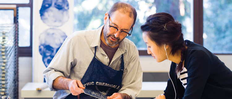 A collaborative scene in a studio, as a man and woman diligently work on a project together.