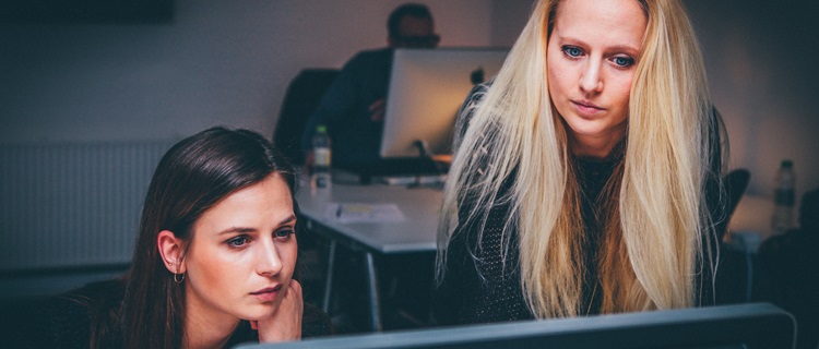 Two women and a computer screen